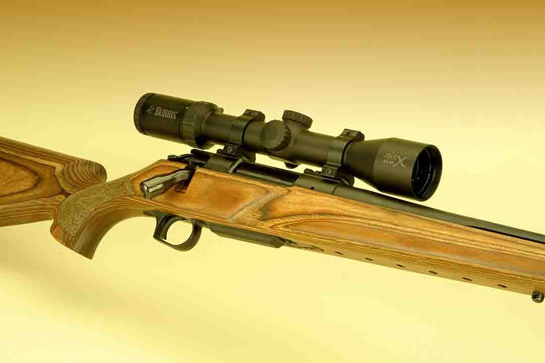 With this profile view, it is easy to see the slick lines of the gun with the Burris scope mounted already to go. The stock is laminated wood, perfect for all-weather use.